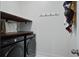 Functional laundry room with washer, dryer, shelving, and hooks at 111 Medford St, Summerville, SC 29486