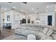 Open-concept living area with a sectional couch, open flow into the kitchen, and ample lighting at 111 Medford St, Summerville, SC 29486