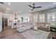 Open-concept living room featuring a plush sectional sofa, stylish rug, and seamlessly connected to the kitchen at 111 Medford St, Summerville, SC 29486