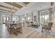 A modern living room featuring elegant decor, wood floors, and natural light from large windows at 111 Medford St, Summerville, SC 29486