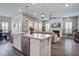 Open-concept living room featuring a kitchen island, stainless steel appliances, a plush sectional sofa, and a fireplace at 111 Medford St, Summerville, SC 29486