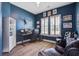 Inviting home office space with computer setup, natural light, and stylish blue walls at 111 Medford St, Summerville, SC 29486