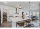 Bright kitchen featuring white cabinets, stainless steel appliances, a large island with seating, and a pantry at 111 Medford St, Summerville, SC 29486