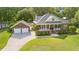Aerial view of a brick house with a green lawn and a detached two-car garage at 1119 Bruton Blvd, Moncks Corner, SC 29461