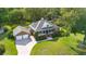 Aerial view of a charming home with a large driveway, manicured lawn, and mature trees at 1119 Bruton Blvd, Moncks Corner, SC 29461