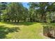 Lush backyard with a mix of grass and trees offers a serene outdoor space at 1119 Bruton Blvd, Moncks Corner, SC 29461