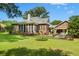 Large grassy backyard with a patio for outdoor entertaining and partial fencing at 1119 Bruton Blvd, Moncks Corner, SC 29461