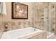 Bathroom showcases a luxurious soaking tub and glass-enclosed shower at 1119 Bruton Blvd, Moncks Corner, SC 29461