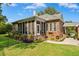 Well-manicured lawn featuring a brick house and porch at 1119 Bruton Blvd, Moncks Corner, SC 29461