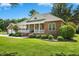 Attractive brick home with a spacious front yard, a welcoming porch, and a detached two car garage at 1119 Bruton Blvd, Moncks Corner, SC 29461