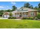 Lovely brick home with a covered front porch, two-car garage and beautiful landscaping in a peaceful setting at 1119 Bruton Blvd, Moncks Corner, SC 29461