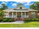Charming brick home with a welcoming front porch, landscaped yard, and classic architectural details at 1119 Bruton Blvd, Moncks Corner, SC 29461