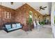 Spacious front porch features a porch swing, rocking chairs, and charming brick accents at 1119 Bruton Blvd, Moncks Corner, SC 29461