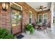 Inviting front porch with comfortable seating, ceiling fan, and a beautifully decorated front door at 1119 Bruton Blvd, Moncks Corner, SC 29461