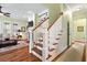 Living room with wood staircase, fireplace, built-in bookshelves, and open layout at 1119 Bruton Blvd, Moncks Corner, SC 29461
