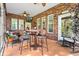 Covered porch featuring a brick wall, ceiling fan, outdoor television and seating at 1119 Bruton Blvd, Moncks Corner, SC 29461