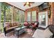 Enclosed sunroom with brick wall, ceiling fan and ample seating at 1119 Bruton Blvd, Moncks Corner, SC 29461