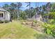 Spacious yard featuring a garden with raised beds, a greenhouse, and mature trees at 119 White Picket Ln, Summerville, SC 29483