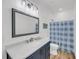 Bathroom features a blue vanity, large mirror, shower with blue curtain, and sink at 119 White Picket Ln, Summerville, SC 29483