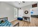 Bedroom features a bed, desk, and view to the living room with wood-look floors at 119 White Picket Ln, Summerville, SC 29483