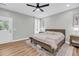 Cozy bedroom with ceiling fan, light walls, patterned rug, and bright natural light at 119 White Picket Ln, Summerville, SC 29483