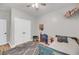 Bedroom features a bed, toy storage, white doors, neutral paint, and wood-look floors at 119 White Picket Ln, Summerville, SC 29483