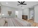 Spacious bedroom featuring a ceiling fan, light walls, wood floors, and ensuite bathroom at 119 White Picket Ln, Summerville, SC 29483