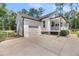 View of the garage and side of the house with well-maintained landscaping at 119 White Picket Ln, Summerville, SC 29483