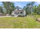 Landscaped front yard leading up to the home featuring a quaint front porch at 119 White Picket Ln, Summerville, SC 29483