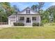 Charming home with a welcoming front porch, manicured lawn, and beautiful landscaping at 119 White Picket Ln, Summerville, SC 29483