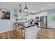 Modern kitchen with white cabinets, stainless steel appliances, and a breakfast bar at 119 White Picket Ln, Summerville, SC 29483