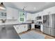 Modern kitchen featuring stainless steel appliances, white cabinetry, subway tile backsplash, and light wood flooring at 119 White Picket Ln, Summerville, SC 29483