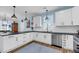Bright kitchen features white cabinets, dark countertops, stainless steel appliances, and stylish pendant lighting at 119 White Picket Ln, Summerville, SC 29483