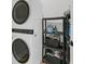 Bright laundry room with stacked washer and dryer, and shelving for storage at 119 White Picket Ln, Summerville, SC 29483