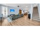 Open concept living room showcases wood-look floors, sofa, staircase, and views to the kitchen at 119 White Picket Ln, Summerville, SC 29483