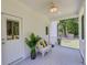Relaxing covered porch featuring a ceiling fan, white wicker furniture, and decorative pillows at 119 White Picket Ln, Summerville, SC 29483