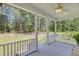 Covered porch overlooking the landscaped backyard and fenced-in animal area at 119 White Picket Ln, Summerville, SC 29483
