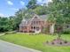 Expansive brick residence with a spacious lawn and mature trees providing ample privacy and shade at 1200 Out Of Bounds Dr, Summerville, SC 29485
