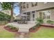 Back deck featuring an outdoor dining set, landscaped yard, and view of the home at 1200 Out Of Bounds Dr, Summerville, SC 29485