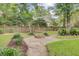 Backyard with a charming fire pit area, swing set and landscaped surroundings at 1200 Out Of Bounds Dr, Summerville, SC 29485
