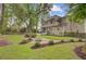Scenic backyard featuring a fire pit area, patio, and mature landscaping at 1200 Out Of Bounds Dr, Summerville, SC 29485