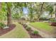Spacious backyard features a fire pit, swing set, and lush landscaping at 1200 Out Of Bounds Dr, Summerville, SC 29485