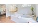 Bright bathroom features a large soaking tub, tiled surround, granite vanity, and access to the main bedroom at 1200 Out Of Bounds Dr, Summerville, SC 29485