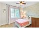 Cozy bedroom with sunny, patterned wallpaper, carpeted floors, and a large window at 1200 Out Of Bounds Dr, Summerville, SC 29485