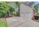Spacious driveway leading to a two-car garage, enhanced by lush landscaping and a basketball hoop at 1200 Out Of Bounds Dr, Summerville, SC 29485