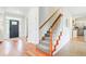 Inviting entryway with wood floors, carpeted stairs, and a view into the kitchen and living spaces at 1200 Out Of Bounds Dr, Summerville, SC 29485