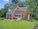 Stately brick house with a green lawn and mature trees creating a serene and picturesque setting at 1200 Out Of Bounds Dr, Summerville, SC 29485