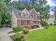 Lovely brick home featuring a well-kept yard, mature landscaping, and a driveway with basketball hoop at 1200 Out Of Bounds Dr, Summerville, SC 29485