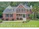 Charming brick home with a welcoming front porch and beautifully landscaped yard at 1200 Out Of Bounds Dr, Summerville, SC 29485