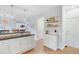 Bright, open kitchen layout with white cabinetry, breakfast bar, and easy access to dining and entrance areas at 1200 Out Of Bounds Dr, Summerville, SC 29485